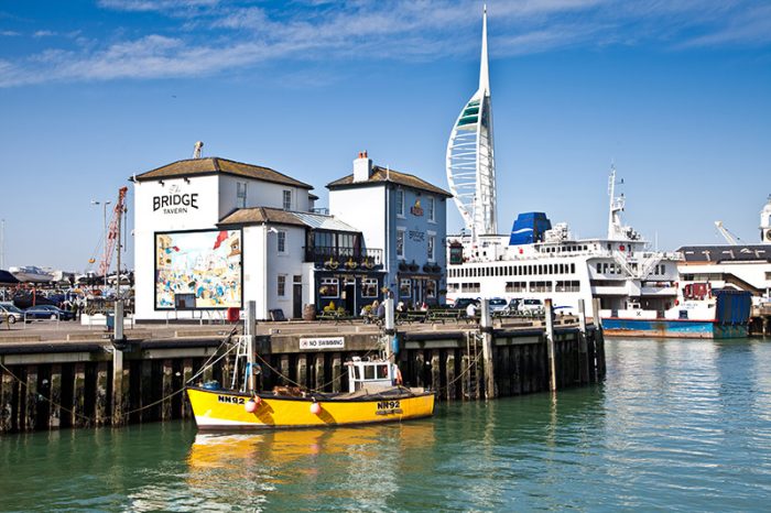 Boats floating in Camber Dock in Old Portsmouth, with the Spinnaker Tower in the distance. Credit: Visit Britain