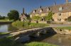 Traditional Cotswold stone cottages and stone footbridge in the Cotswolds village of Lower Slaughter. Credit: Visit Britain