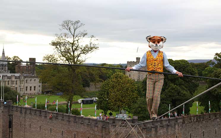 EDITORIAL USE ONLY High wire walker Chris Bullzini walks from Cardiff Castle as Fantastic Mr Fox as part of ëRoald Dahl's City of the Unexpectedí in Cardiff presented by Wales Millennium Centre and National Theatre Wales to celebrate the 100th birthday of author Roald Dahl. PRESS ASSOCIATION Photo. Picture date: Saturday September 17, 2016. The large scale production is expected to attract 20,000 members of the public and other attractions include a mass wedding and a fox on a tightrope. Photo credit should read: Geoff Caddick/PA Wire